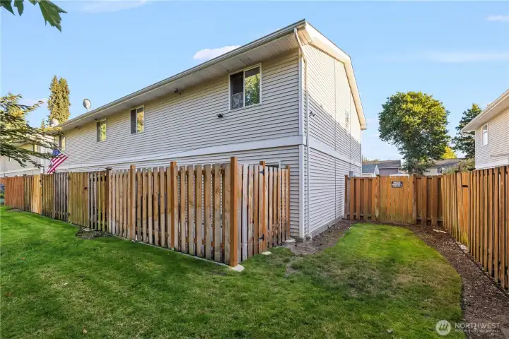 Step outside to a green backyard space with your own private patio. Perfect for entertaining, this area includes a gate that leads out back while keeping the patio fully enclosed for privacy.