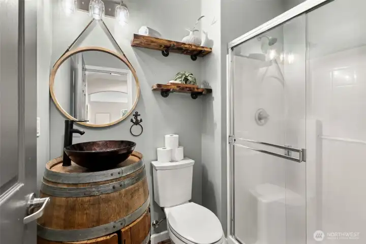 Downstairs you'll find a 3/4 bath with a custom Fishtale brewery barrel that was transformed into a bathroom vanity!