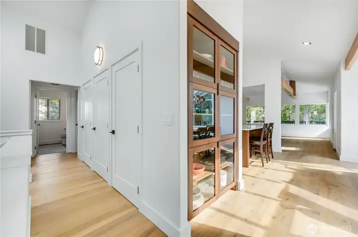 New built-n curio cabinet with walnut wood and class doors showcase your collections or dishware. new engineered floors, re-stained wood beams, new entryway skylight, new trim and base throughtout are a few of the new features in this home.