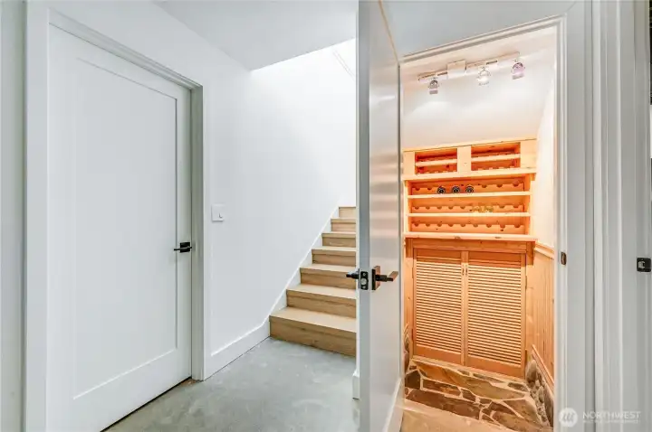 To the right of the stairs is wine storage and storage underneath the stairs. A large storage room is on the left.
