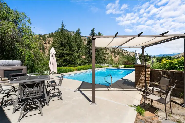 Covered pergola patio designed for effortless outdoor living—dine, relax, and entertain poolside while taking in expansive mountain views.