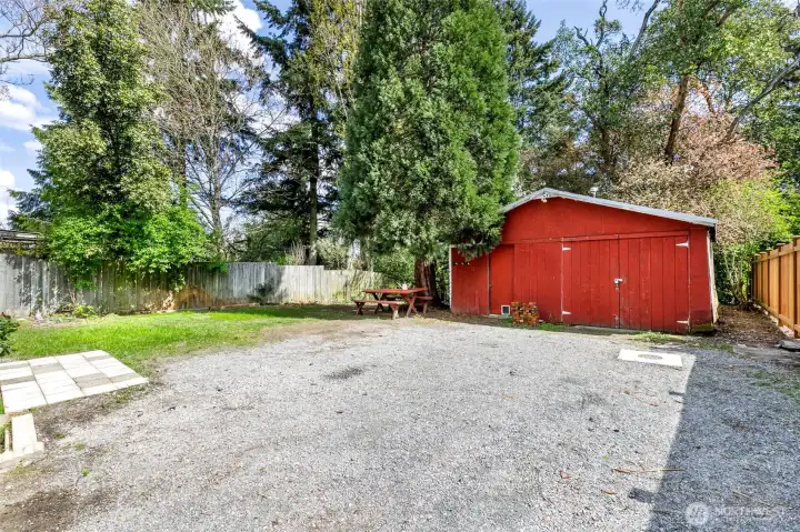 You come down the driveway towards the back and there is a 1/1/2 car garage with a work shop space and power in the shop