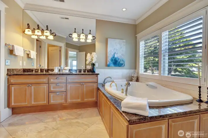 Primary bath with marble and travertine finishes