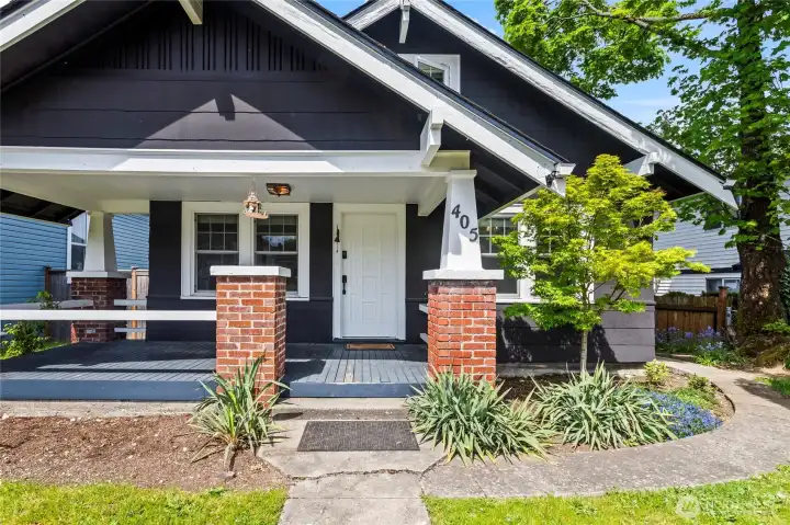 A classic covered porch or a path to the fully fenced back yard