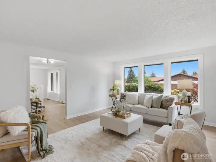 Across the way is the formal living room with more appealing windows. Across the way is the formal living room with more appealing windows.