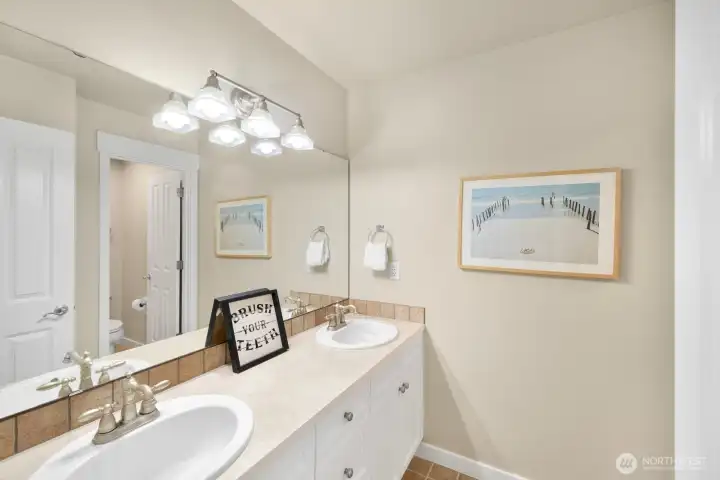 Upstairs full bathroom with separate area for shower and commode.