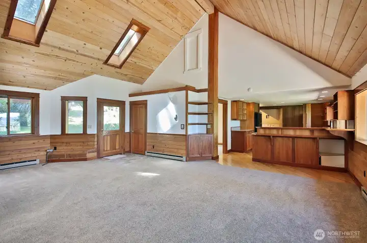 Door in the center of the photo leads to your back deck. There is a coat closet to the right of the back entry (ceramic tile at this entry). More custom built-ins in that corner between the kitchen and living room.