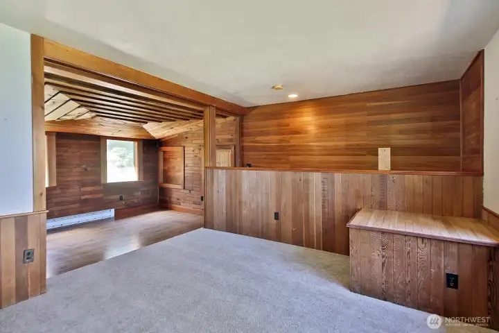 We are now upstairs. The stairs land you straight ahead on the oak floors. You step up to the carpeted area (brand new carpet here). Windows to your view are beyond the right edge of this photo.