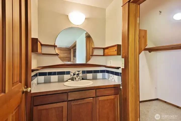 Check out all the handcrafted cherry shelving and cabinetry. Walk-in closet to the right of the sink.