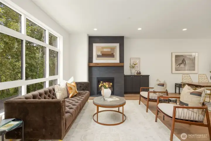 Expansive, light-filled great room featuring rich hardwood flooring, custom recessed lighting, and a sophisticated neutral palette.