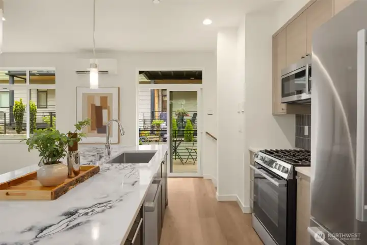 Close-up of the high-end finishes, premium appliances, and functional breakfast bar seating on the expansive island.