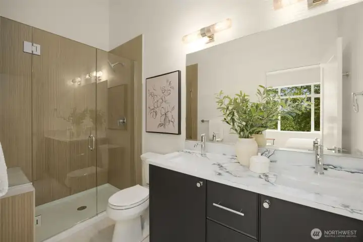Designer primary bathroom boasting a custom dark floating vanity, premium sleek black plumbing fixtures, and a seamless glass shower with elegant modern tile.