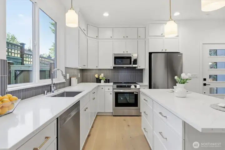 Quartz countertops with undermount sink and extensive backsplash. Quartz countertops with undermount sink and extensive backsplash.