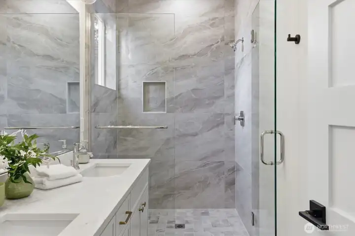 Large shower with glass doors. Large shower with glass doors.