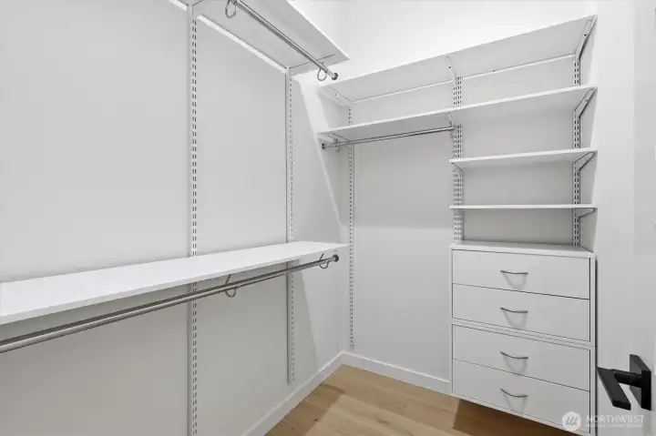 Primary's walk-in closet with built-ins. Primary's walk-in closet with built-ins.
