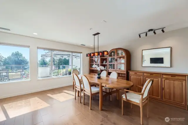 The spacious dining room enjoys stellar views and an art glass chandelier.