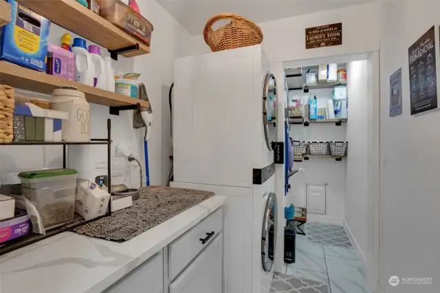 Spacious laundry room with built-in cabinetry and extra space for your storage needs.