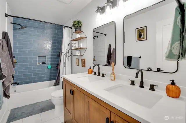 Full bath on the upper level with a dual sink vanity and a tub/shower combo.