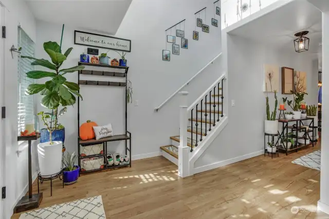 Vinyl plank flooring at the entry flows throughout the main living areas.