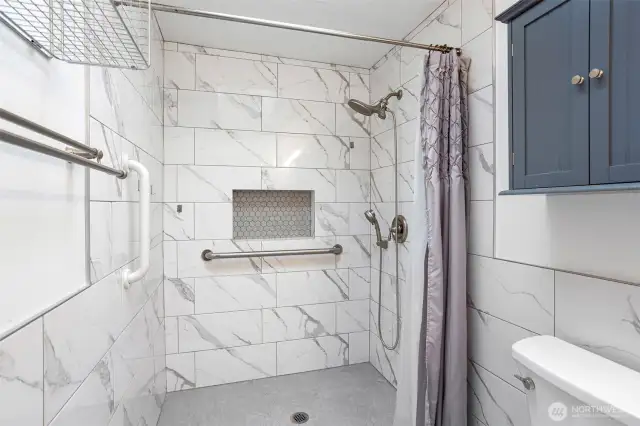 Walk-in shower in primary main-floor bedroom