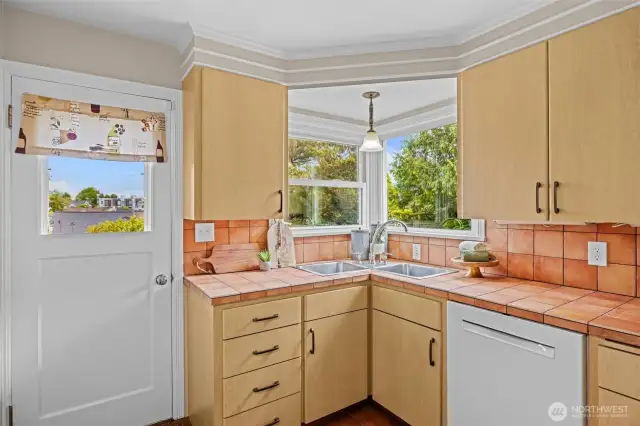 Love the corner sink and window as you enjoy your well manicured yard