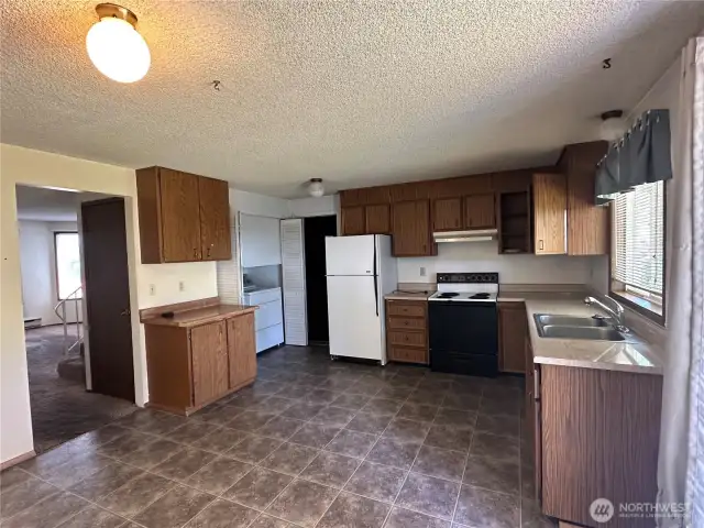 Note the laundry in the corner and the door to the garage for direct access.