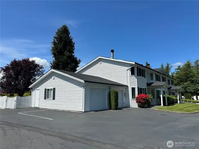 The unit for sale is the 1st one on the left by the rhododendron  The garage for this unit is the one attached to the unit. (not the one on the left with a separate door)