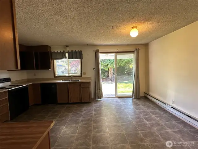 Kitchen and dining with slider to back