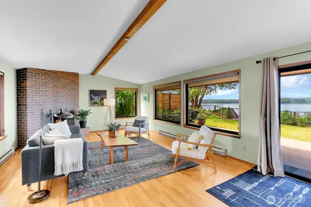 The living room is flooded with light from the east windows and the south and west facing wall of windows. All windows have solar shades.