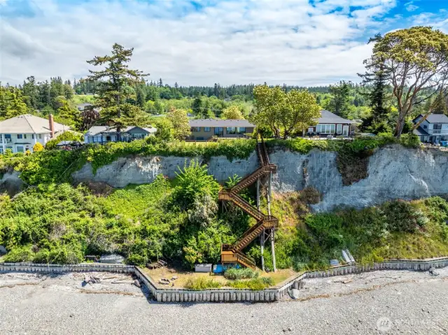 View from the water of the bluff, home and stairs.