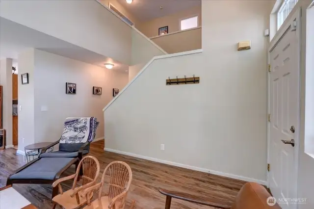 View of the open staircase and vaulted ceilings.