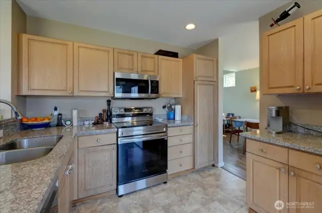 Kitchen with new and/or newer stainless steel appliances and granite countertops.