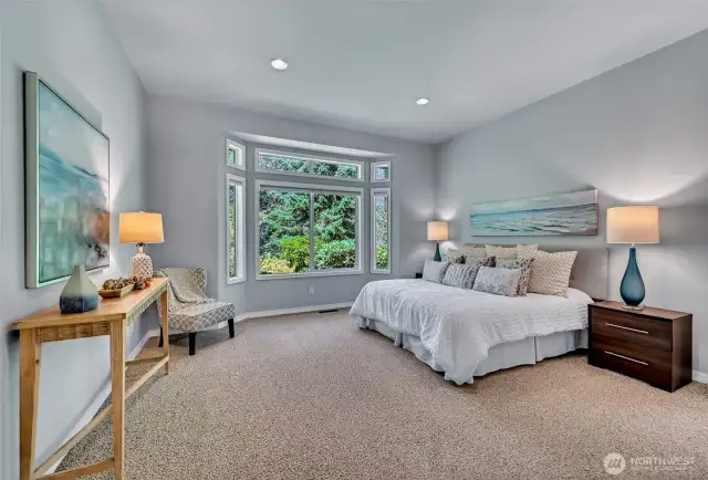 The primary bedroom overlooks the greenbelt and has two walk-in closets. One in the bedroom and one in the bathroom.
