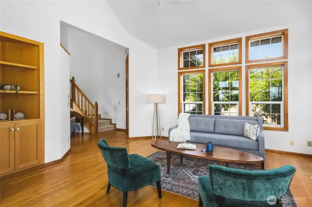 Living room is bright with windows on all sides.
