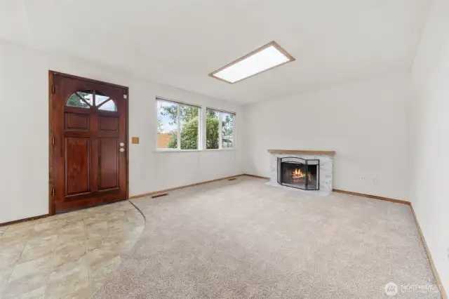 Good size living room with wood burning fireplace.