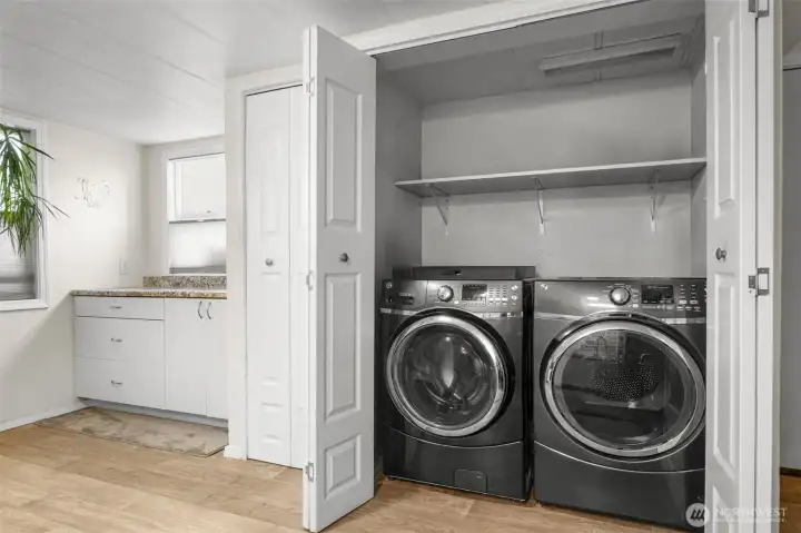 Laundry space with storage above. Washer and dryer stay.