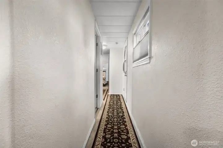 Down the hall to the 2 bedrooms, bathroom, and 2 additional exterior access options.