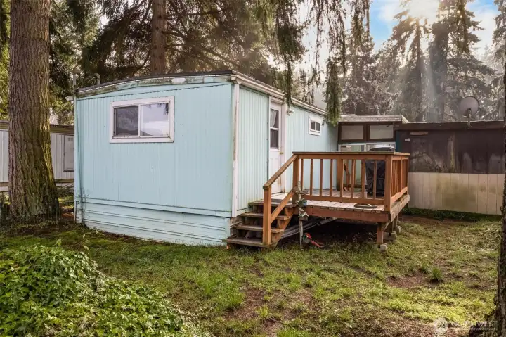 Another view of the yard looking toward the shed at the back of the carport.