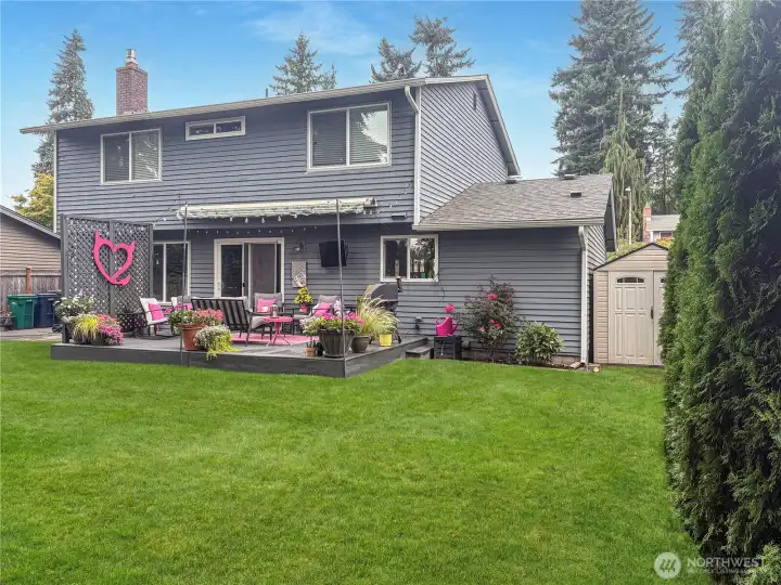 Full fenced backyard with storage shed.