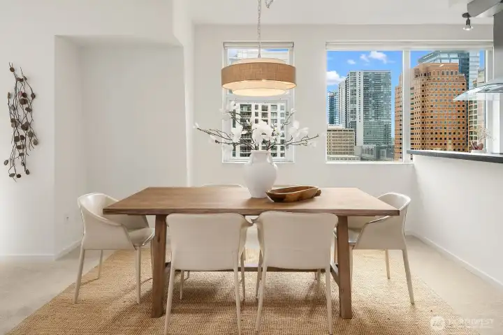 Dine beneath stylish pendant lighting with sparkling city lights in the background.