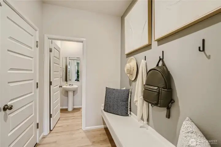 Garage door, cool drop zone and powder bath.   Photos are representation as the home is under construction.