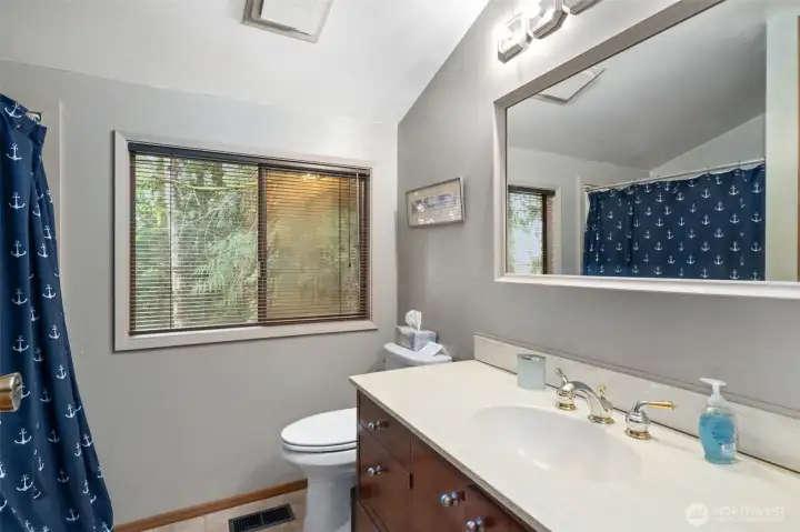 Upstairs bathroom with large shower w/seat.