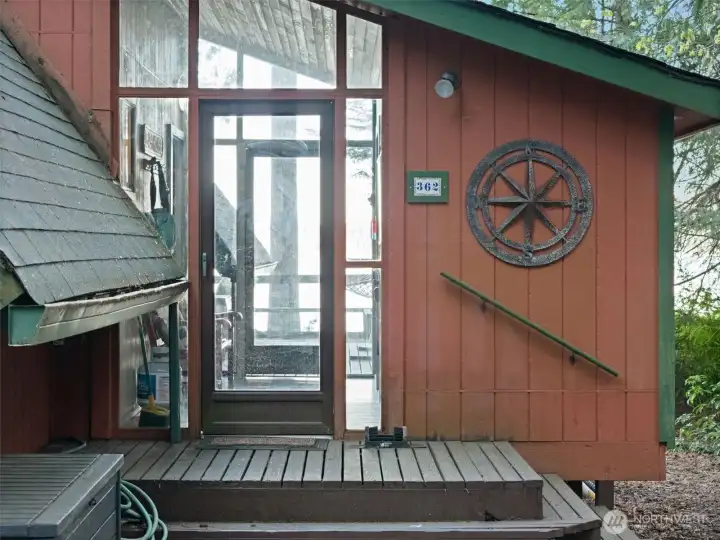 Entry porch with storage room on side.