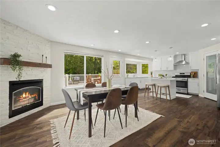 lovely modern kitchen and dining room with fireplace. Tons of natural light and direct access to the deck.