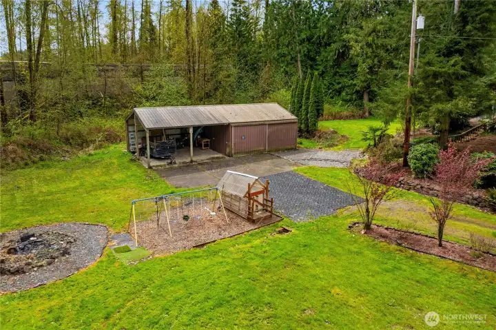 Large shop with additional carports, previously used as home gym-- possibliities are endless. Swing set/play area, firepit.