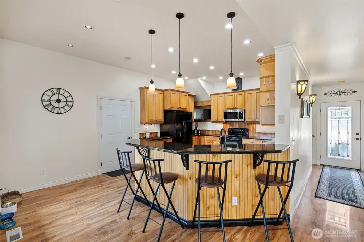 Chefs kitchen with ample counterspace and buffet style seating,