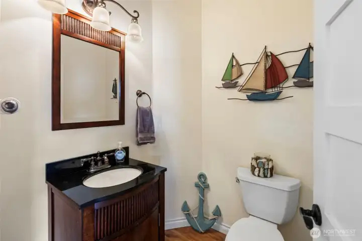 1/2 bathroom located off the kitchen area in main entrance hallway.