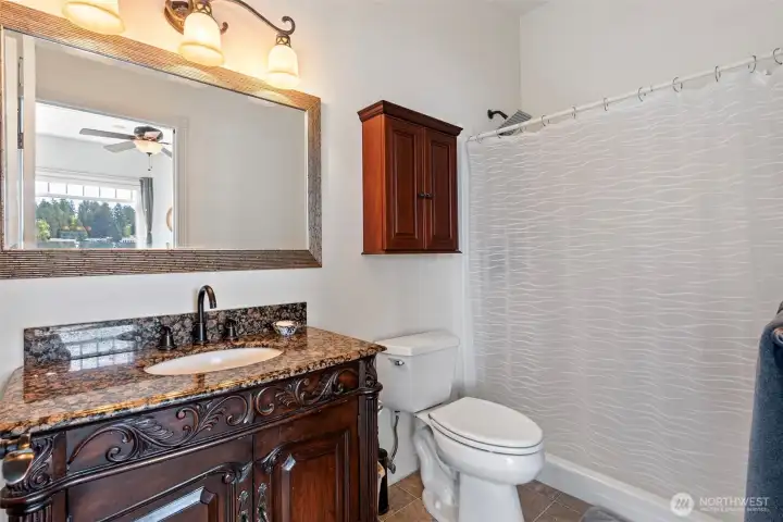 Primary bathroom offset of the large walk in closet. Easy entrance shower.