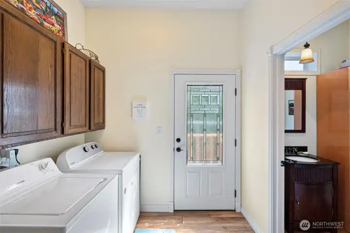 Mud room/ 1/2 bath with the door leading to the lake and outside shower