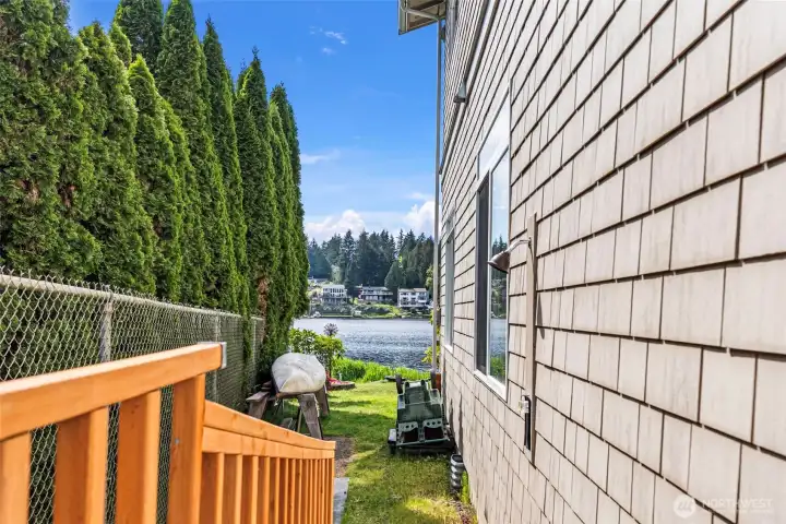 Side yard with the outside shower for rinsing off after enjoying the lake.